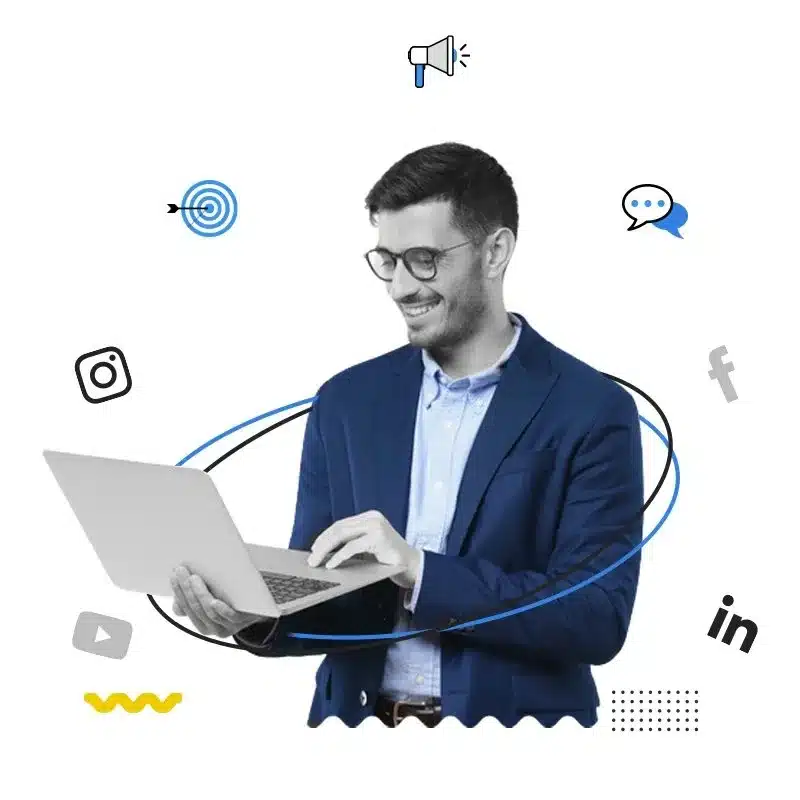 man with smiling face holding Macbook laptop in hand and surrounded with social icons working in digital marketing agency in dubai